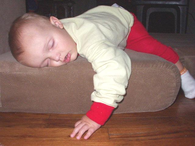 Elijah fell asleep on the couch cushion that was on the floor.