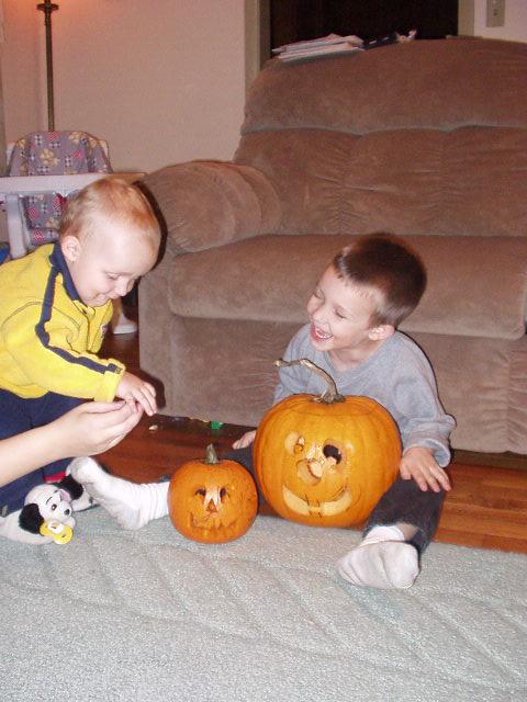 Timothy thought it was funny that we were trying to put Elijahs pacifier in the pumpkins mouth. I was just trying to get Elijah in the picture :)