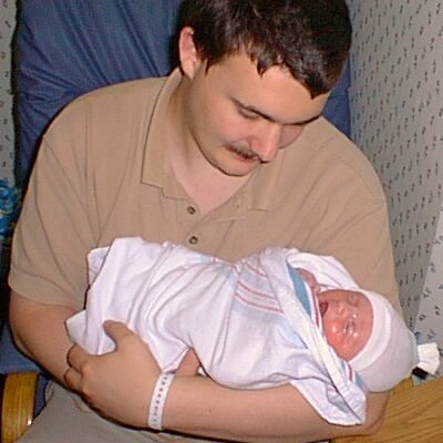 This is Elijah in the hospital just after he was born being held by his father