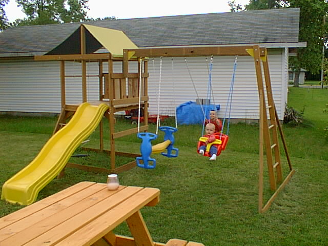 Timmy and Eli swinging in their swings.