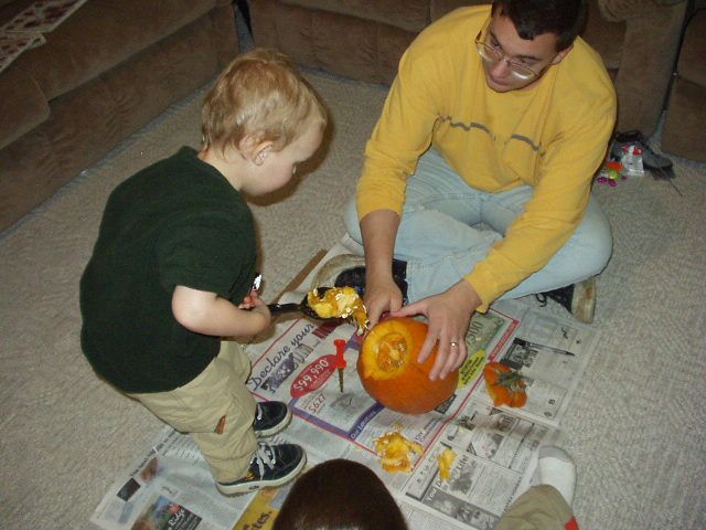 Elijah is helping scoop out the seeds.
