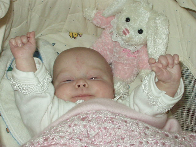 Mamaw bought Mary her first Easter bunny. Mary looks like she wants picked up.
