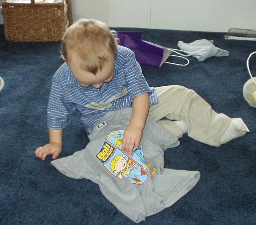 Elijah is looking at his new Bob the Builder shirt from Mamaw, Aunt Joni & Uncle Bruce.