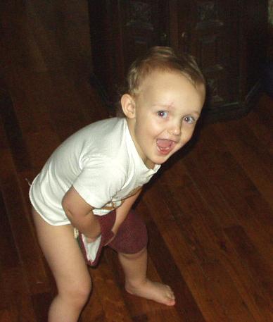 Elijah was running around with my oven mitt. I just thought this was a cute picture.