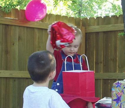 Timothy wanted to help Elijah open his gifts.
