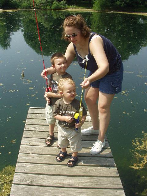 Timothy and Elijah are holding up (with my help) their first catch of the day. (Notice the size of Timmy's and then the size of Elijah's) hehe