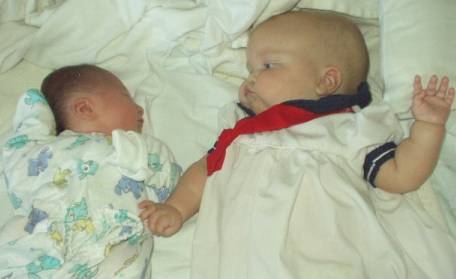 Mary is protecting baby Nicholas. (or trying to get a high five!)