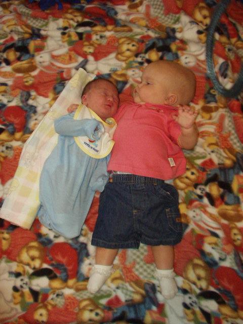 Mary has her arm around baby Nicholas :) Mary actually looks big next to him.