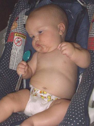 Mary was trying to sing with her spoon.  (looks like she is trying to snap her fingers also)