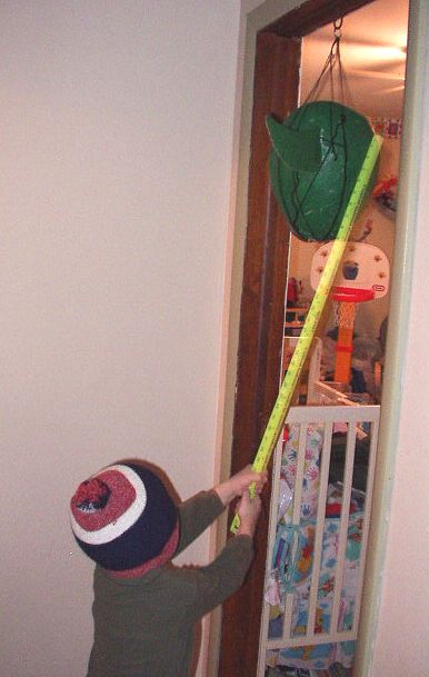 Timothy is trying to brake the piñata open.