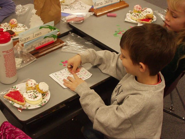 Timothy is playing the bingo game that we put together. I cut *400* little stockings and balls out!!!! I MUST love that boy!!! :):)