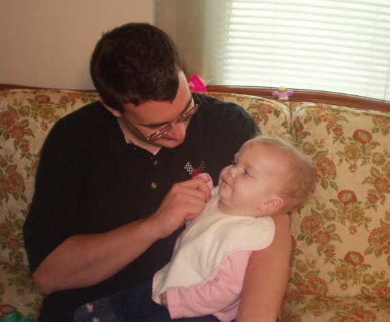 Daddy is trying to get Mary to smile :)