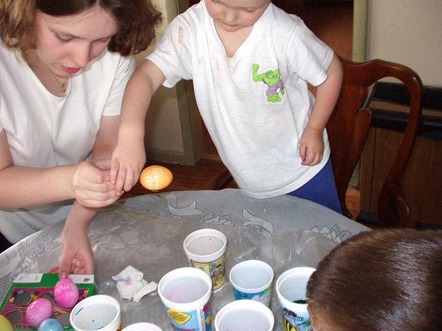 Mommy is helping me put the egg down to dry.