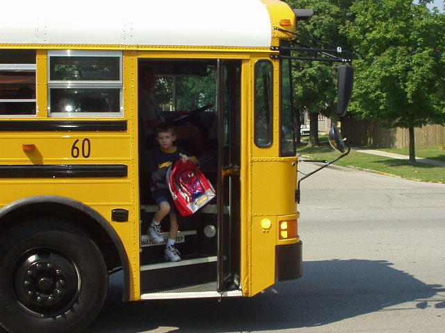 Timothy getting off the bus after his first day of school!!