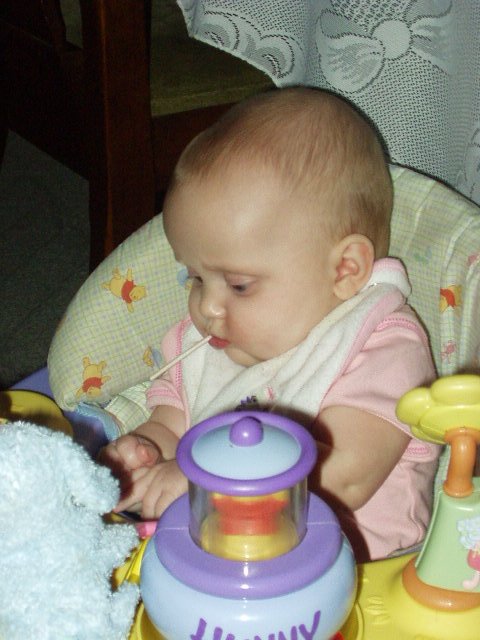 Abigail looks like she is trying to type with the sucker in her mouth.