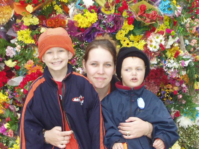 Timothy, Mommy and Elijah with the flowers :) hehe  Elijah was in the middle of a dino roar!!