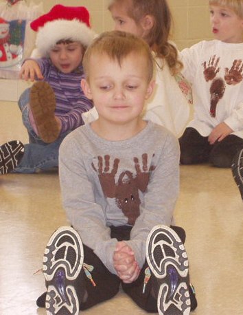 Elijah is sitting on the floor looking so sweet!!! haha