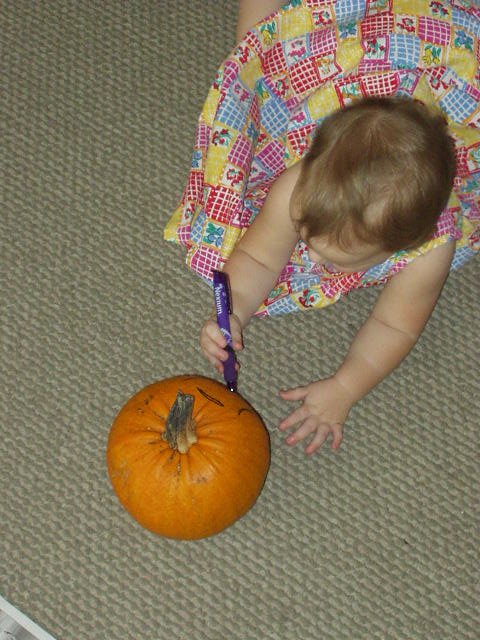Abigail is getting her pumpkin ready to carve!