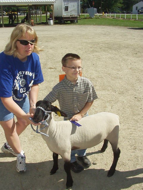 Timothy is showing off his blue ribbon :)