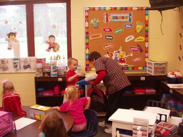 Elijah is showing Mrs. Jackson all of his supplies!