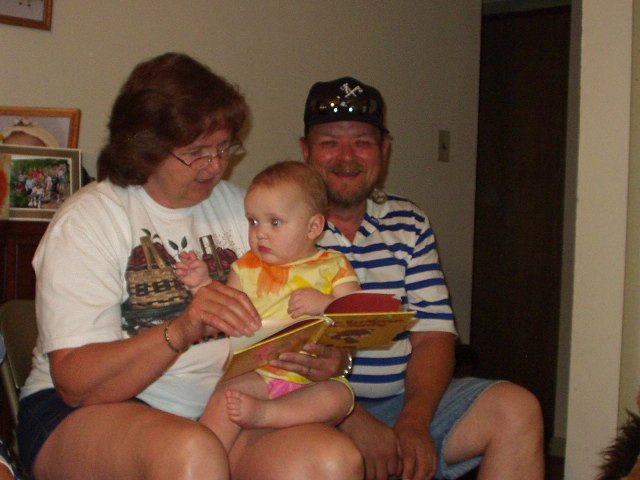 Janet is reading Abigail a book and Poppy is laughing at Mommy being funny!!