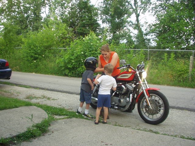 Elijah is telling Nicholas how you ride a motorcycle :)
