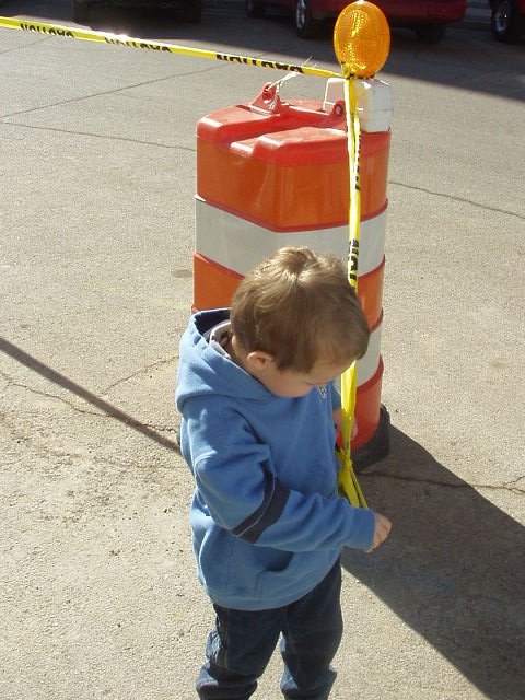 This is another way to keep Elijah out of trouble.... Tie him with 'Caution' tape to an orange barrel :) hehe