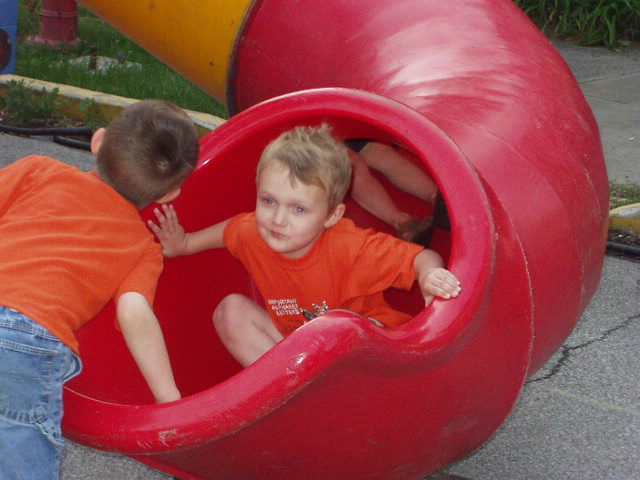 Timothy started to climb back up the slide to find Elijah :) 