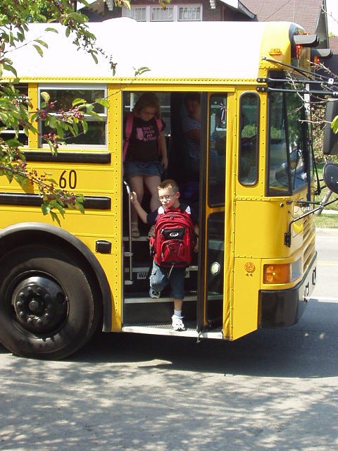 Timothy getting off of the bus after a fun day at school!!!