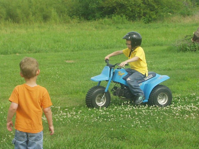 Timothy rode the 3-wheeler for the first time. Of course I didn't get a picture of him falling off...or the marks on his chest :O (woops)