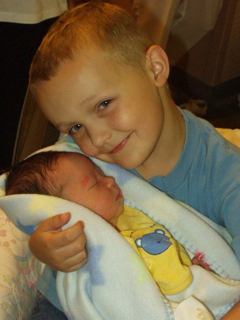 Elijah looks so big holding Aidan!