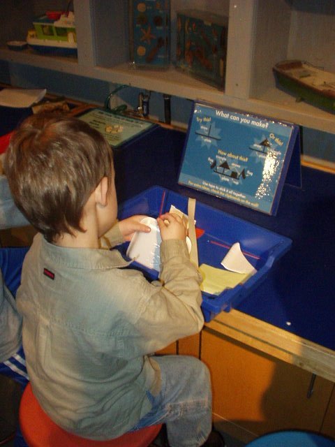 Elijah is building a boat out of misc recycled products :)