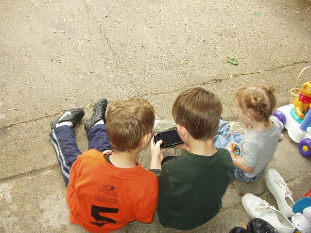 Elijah and Abigail watch Timothy play his PSP while they wait for the next customer :)