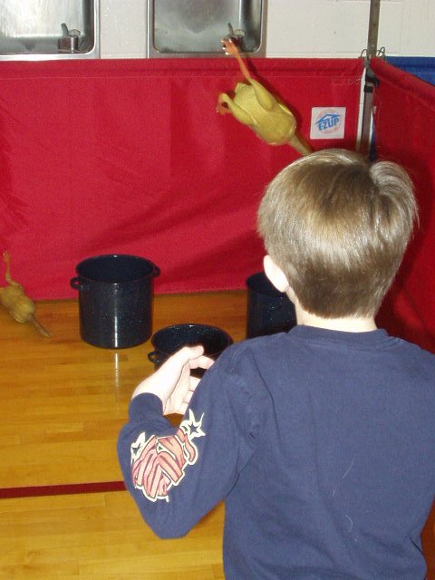 Timothy is playing toss the chicken :) He landed one in the pot!!