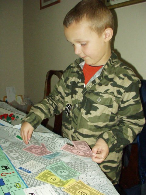 Why do I always have to give Mommy money?? .o0 Daddy thinks the same thing! 0o.