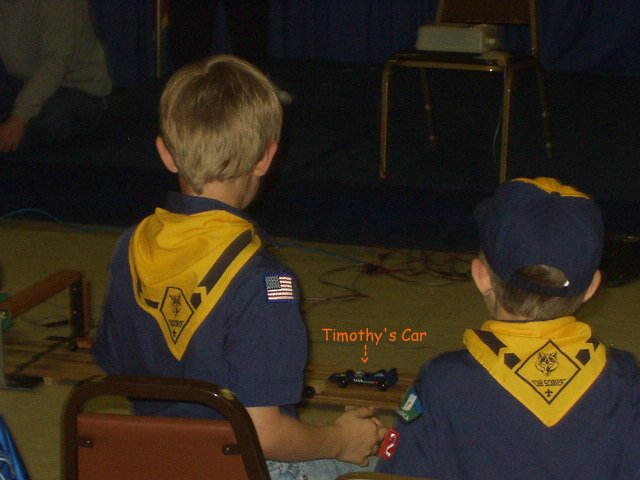 Timothy watching his car race by....