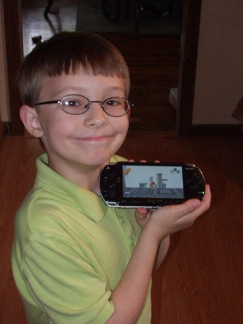 Timothy and his new PSP!! The Portable Entertainment Revolution Has Arrived!! (at least that is what the website said!) hehe