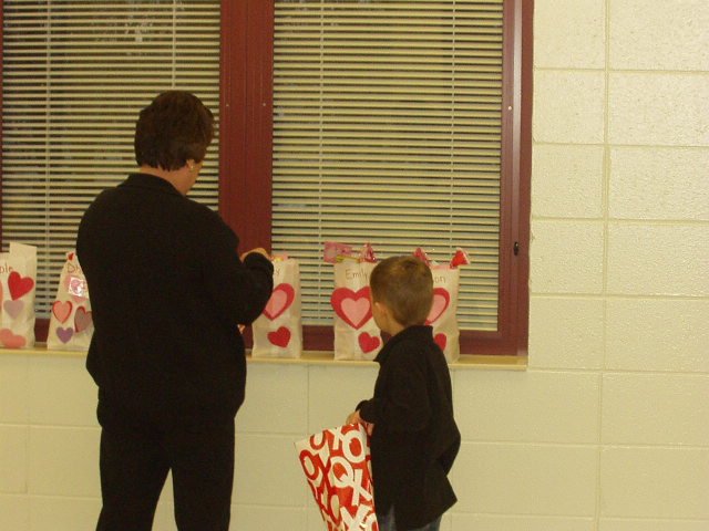 Mrs. Jackson is helping Elijah with his cards.