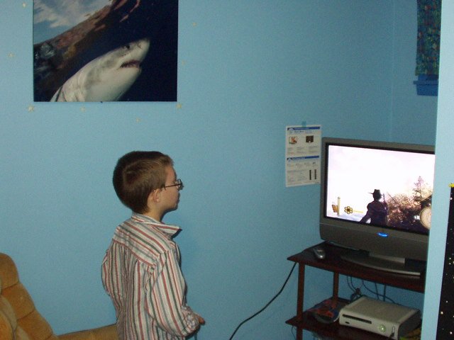 Timothy in his new little game corner :) The kids used their Christmas gift of Toys R Us cards and bought an XBOX 360. ((weeeeehoooo!!! it's fun!))