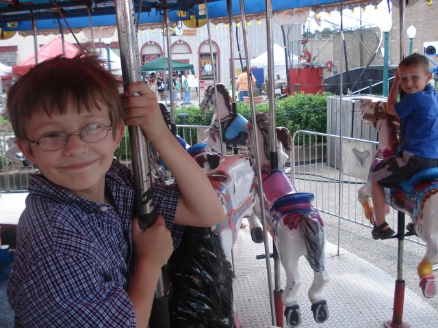 Timmy's almost too big for the Merry-go-Round!