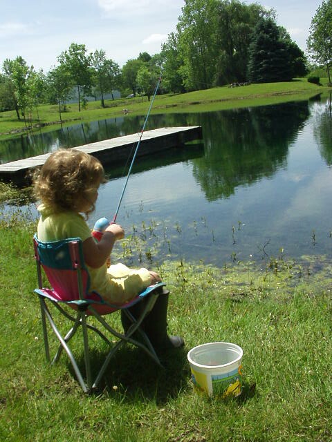 Abigail is all set up. Chair, pole and worm bucket!