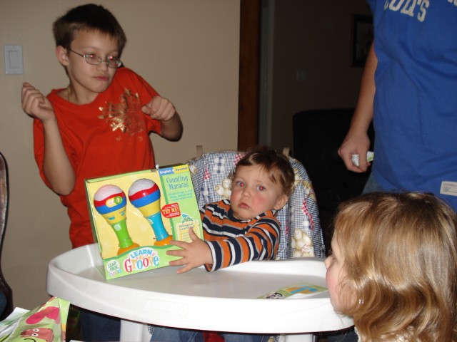 Maracas!  I think Timmy is doing Dora's "We did it" dance.