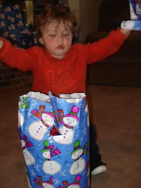 Isaiah is the perfect age to have fun unwrapping presents.