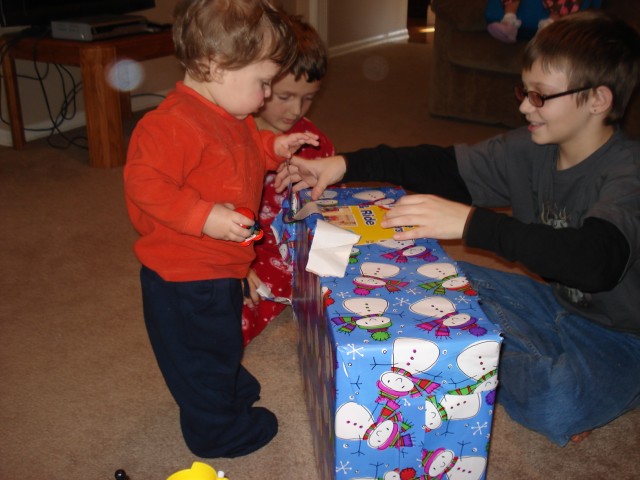 The boys helped Isaiah unwrap his next gift :)