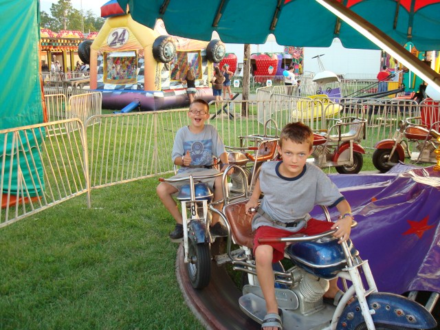Elijah is too cool for the kiddie motorcycle.
