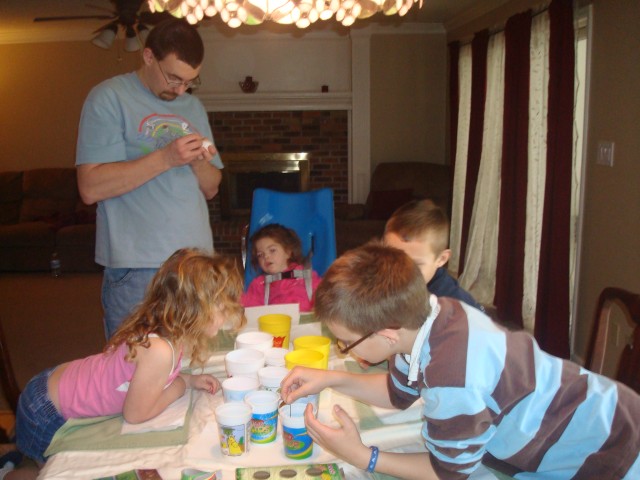 Daddy is writing on Mary's egg.