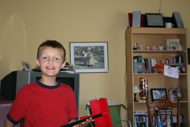 Elijah likes toy cleaning supplies.