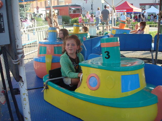 Abby is almost too big for the kiddie rides!