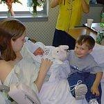 This is timothy giving his new brother Elijah his first stuffed animal.