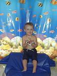We sent Elijah to a tropical paradise for his birthday. (hung a curtain up at Mamaws, sat him on blue plastic wrap and gave him fish hangers to hold:) hehe